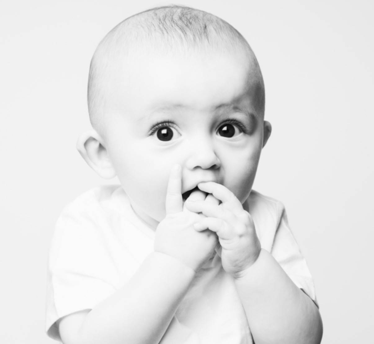 Black-and-white portrait, boy B, fingers to mouth