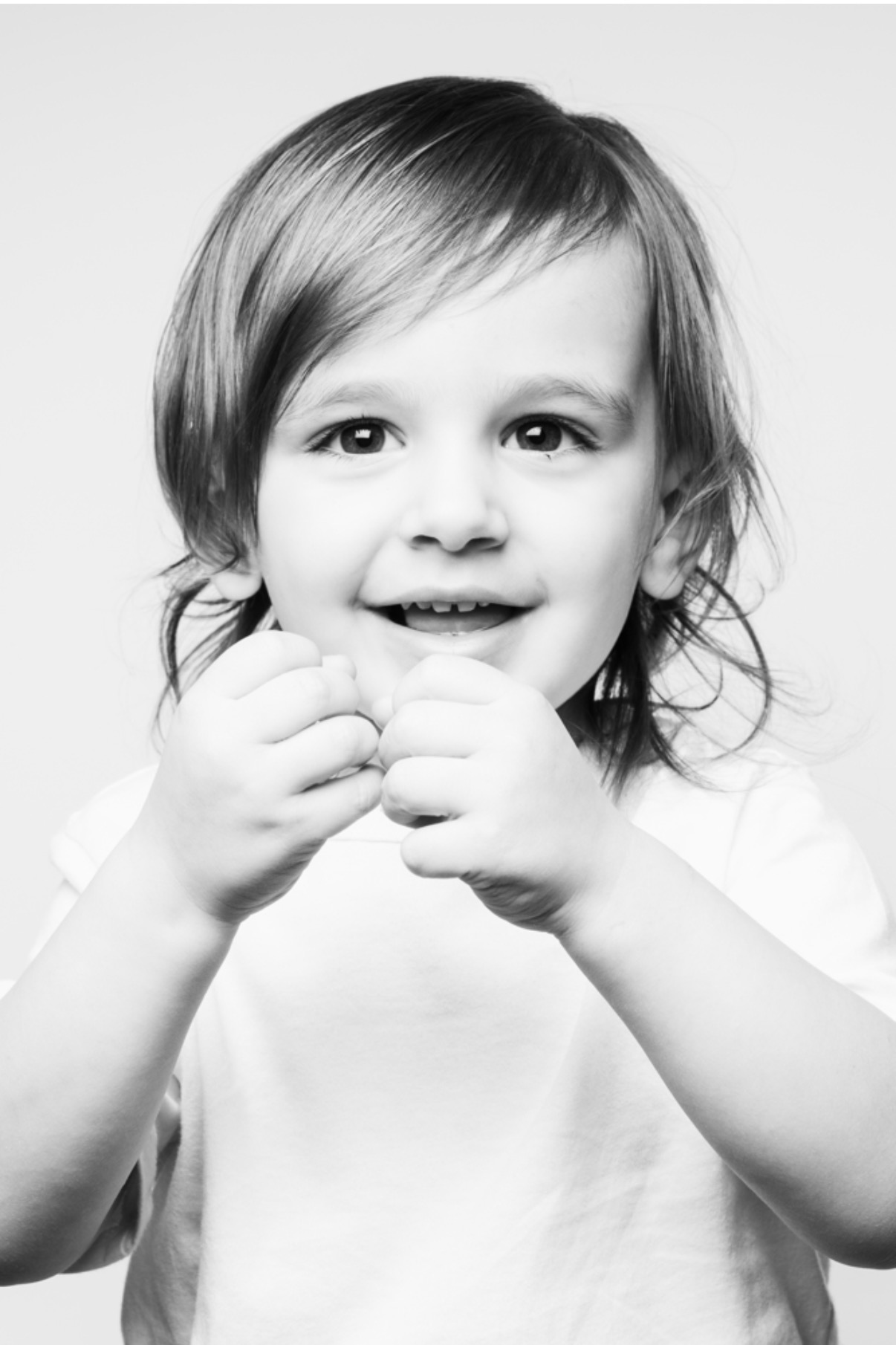 Black-and-white portrait, boy A, smiling with hands up